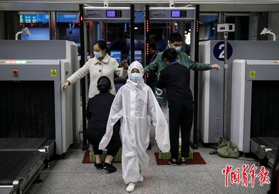 4月7日晚11点40分,武昌火车站,一名穿着防护服的小女孩进站候车.