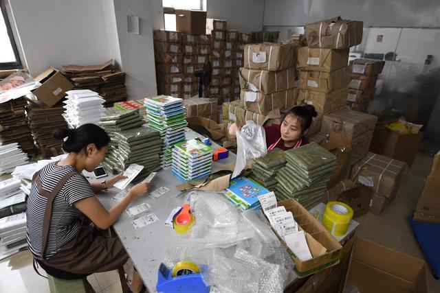 6月22日,在沭阳国际图书城一家书店,工作人员打包图书.