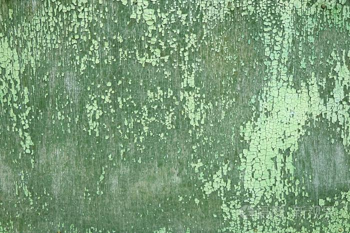 剥落的绿漆上褪了色的木背景.油漆脱落