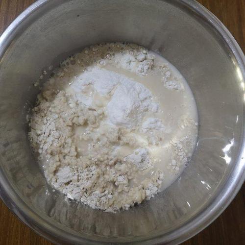 第2步,两种面粉混合后,加入水和发酵粉,和成软一些的面团.